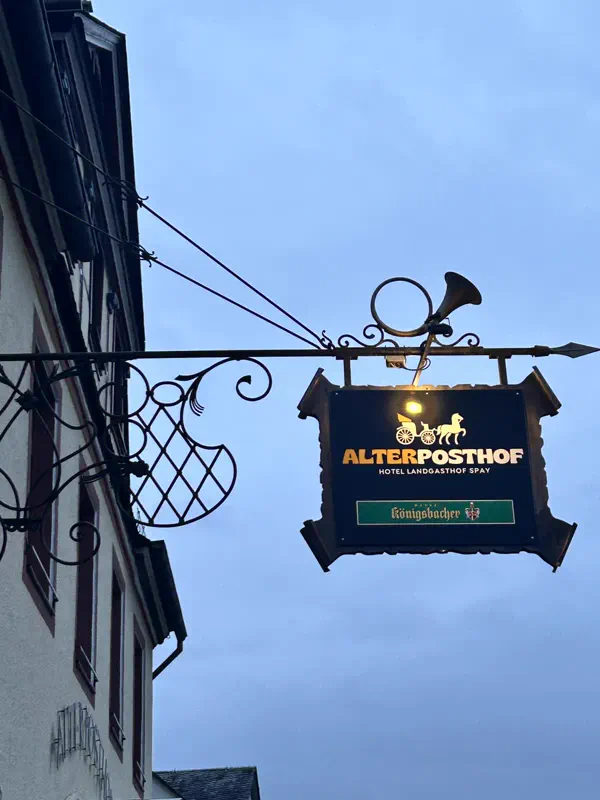 Wirtshausschild mit Posthorn am Hotel Alter Posthof in Spay
